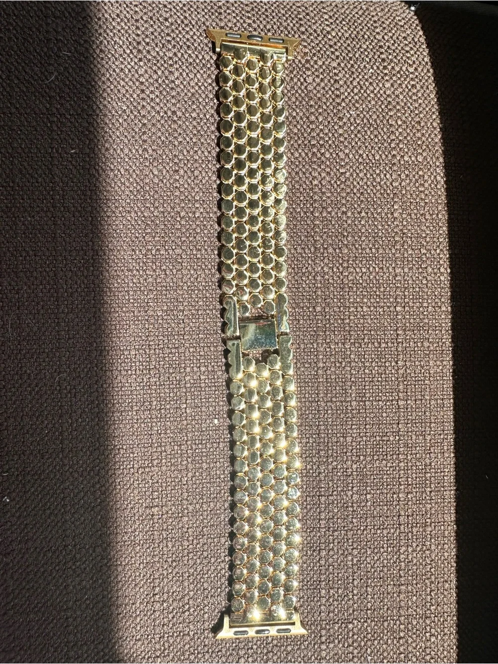 Honeycomb stainless steel strap in gold tone for Apple Watch.